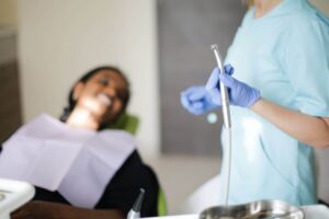 woman lying in chair beside standing dentist with national locum tenens dentist jobs