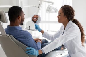 dentist showing patient his teeth
